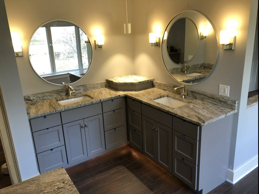 A modern bathroom vanity installation with dual sinks and granite countertops by Shafer Construction, LLC in Bethlehem, PA.