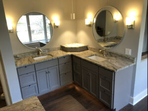 A modern bathroom vanity installation with dual sinks and granite countertops by Shafer Construction, LLC in Bethlehem, PA.