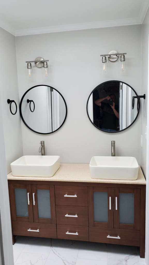 A newly installed bathroom vanity with dual vessel sinks and mirrors by Husbands On Call in Virginia Beach, VA.
