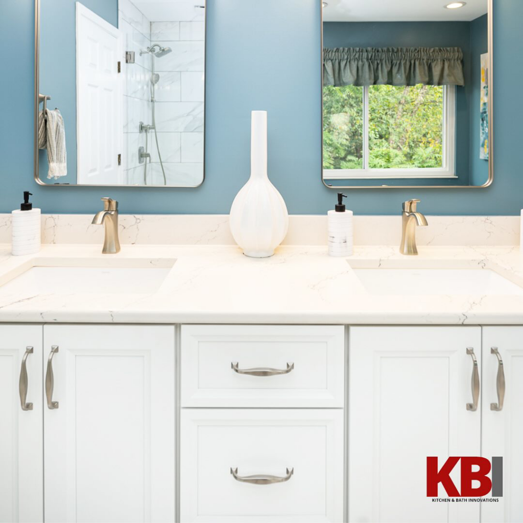 A newly installed double bathroom vanity with white cabinets and sinks by Kitchen and Bath Innovations in Cincinnati, OH
