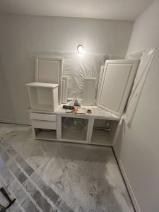 Bathroom vanity installation in progress with new cabinets and protected floor by Michael South Home Renovations in Fort Worth, TX.
