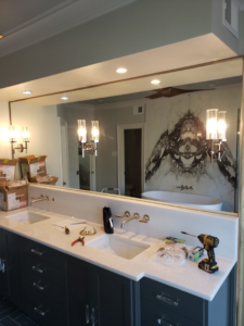 Tools and parts on a bathroom vanity during an installation or repair by Jesse Reed Construction, LLC in Memphis, TN.