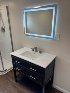 A newly installed bathroom vanity, sink, and illuminated mirror by Fox Renovations in Knoxville, TN