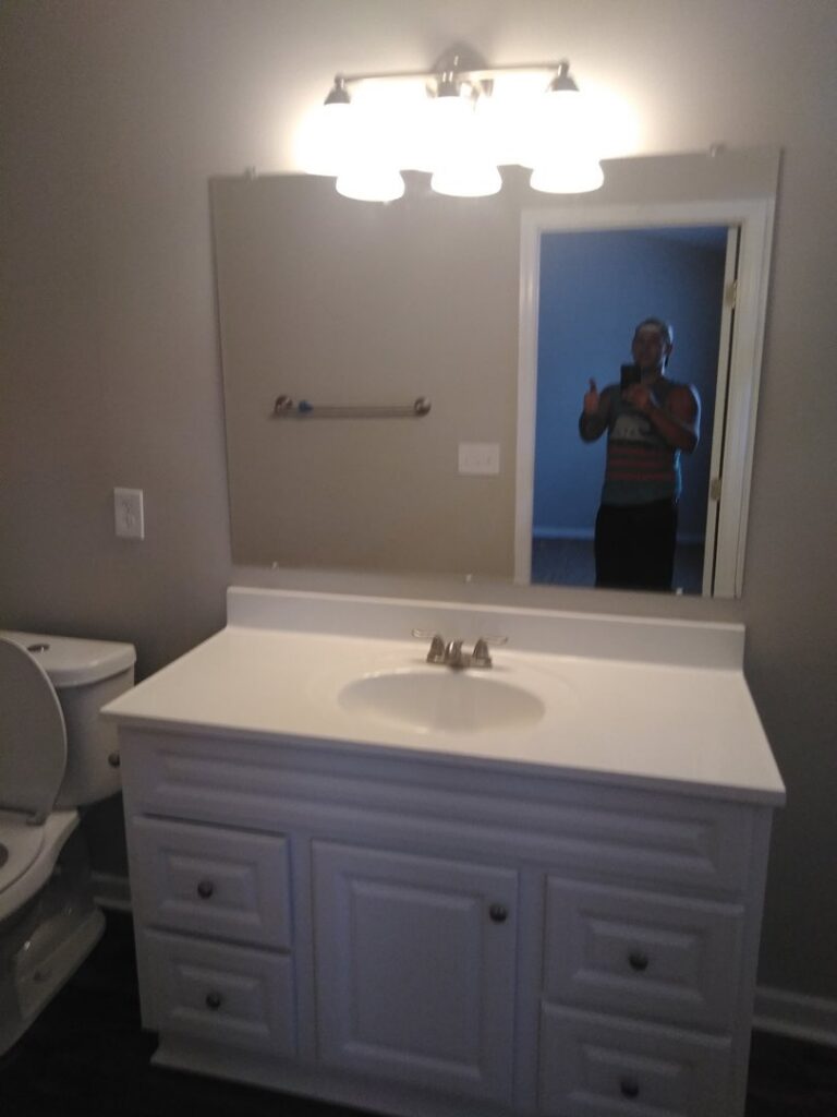 New bathroom vanity and mirror installation by Holy City Remodel in North Charleston, SC.