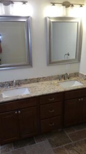 A newly installed bathroom vanity with double sinks and mirrors by Priority One Home Repair LLC in Glendale, AZ
