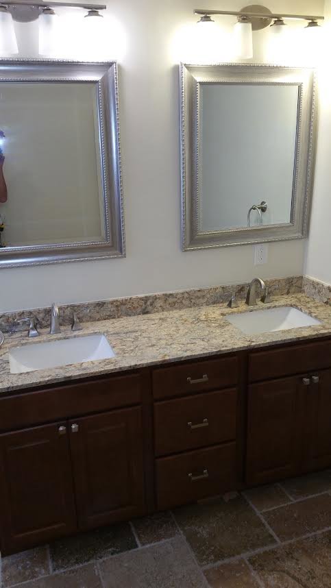 A newly installed bathroom vanity with double sinks and mirrors by Priority One Home Repair LLC in Glendale, AZ