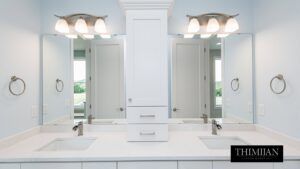 A double vanity bathroom with white cabinets, dual sinks, and mirrors, installed by Thimijan Custom Homes LLC in Rochester, MN