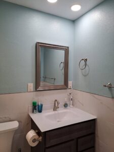 A newly installed bathroom vanity, sink, and mirror by Victor White Handyman in Long Beach, CA