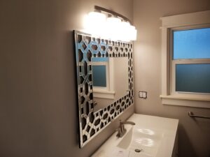Newly installed bathroom vanity mirror and light fixture by ALKA Construction/ Handyman Services in Layton, UT