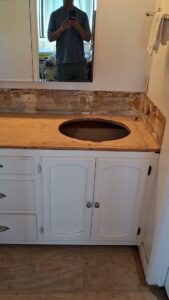 A bathroom vanity undergoing renovation with the countertop removed and a sink cutout, demonstrating work by Handyman SanDiego in San Diego, CA.