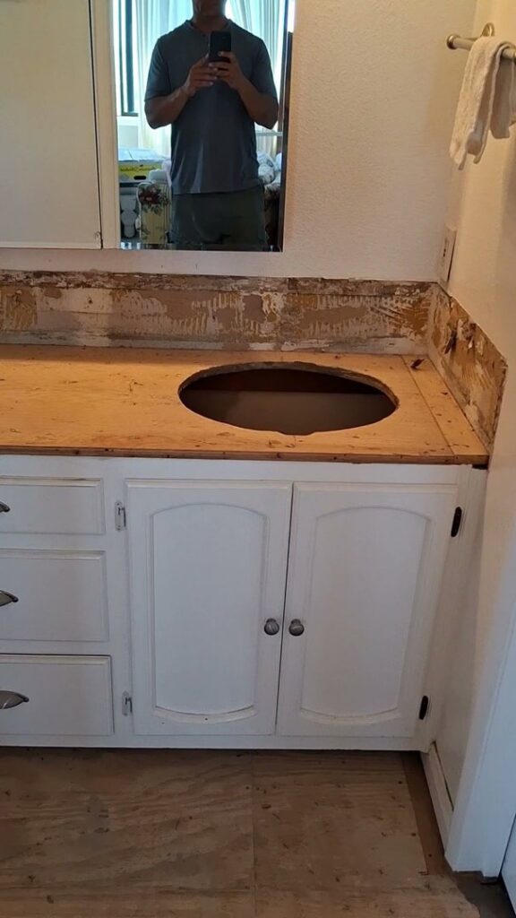 A bathroom vanity undergoing renovation with the countertop removed and a sink cutout, demonstrating work by Handyman SanDiego in San Diego, CA.