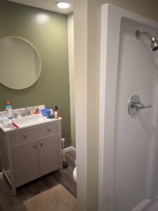 A newly installed bathroom vanity, sink, and shower stall by D-N-M Construction & Property Maintanence LLC in Dayton, OH.