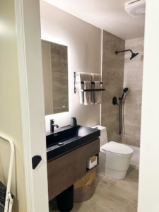 A renovated bathroom featuring a modern vanity, black sink, and shower by Blue Ribbon Renovations in Elizabethtown, KY.
