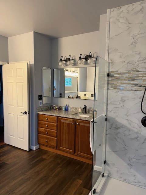 A completed bathroom vanity and shower area renovation by Peninsula Bath & Tile in Salisbury, MD.