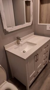 A newly installed bathroom vanity with a modern sink and faucet, part of a bathroom update by Go Joe Handyman in Overland Park, KS.