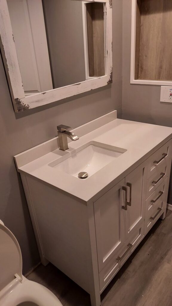A newly installed bathroom vanity with a modern sink and faucet, part of a bathroom update by Go Joe Handyman in Overland Park, KS.