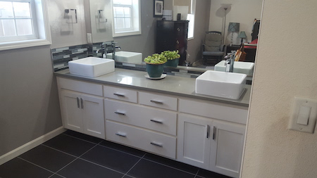 Bathroom vanity, sink, faucet, and mirror installation by Girard Builders in Medford, OR.
