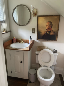 A newly installed bathroom vanity, sink, and mirror in a small bathroom by Anderkin Remodeling in Cincinnati, OH