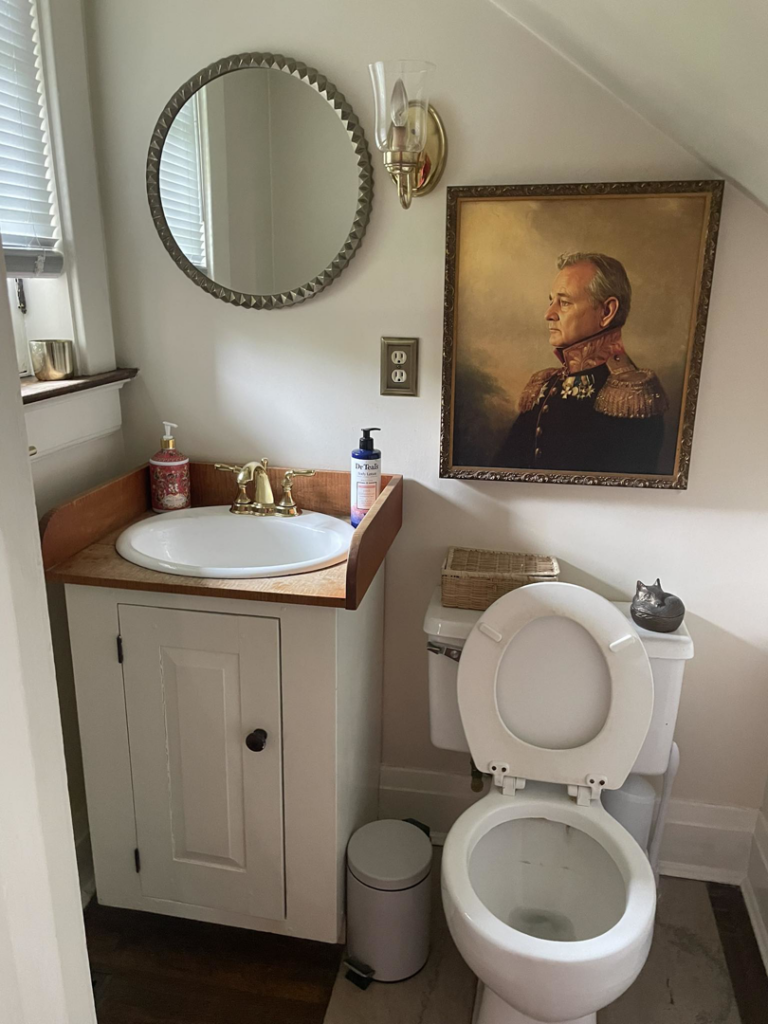 A newly installed bathroom vanity, sink, and mirror in a small bathroom by Anderkin Remodeling in Cincinnati, OH
