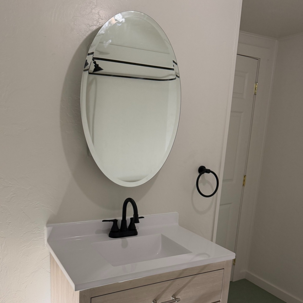 A newly installed bathroom vanity, sink, faucet, and mirror by Davis Home Dynamics in Springfield, OR