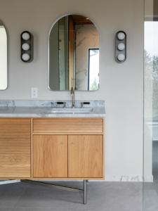 Bathroom vanity, sink, mirror, and wall lights installed as part of a remodel by JDI Construction in Vancouver, WA.