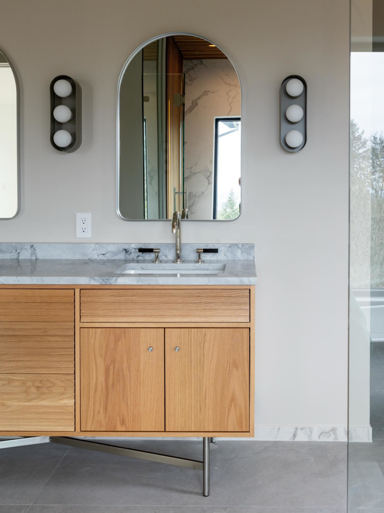 Bathroom vanity, sink, mirror, and wall lights installed as part of a remodel by JDI Construction in Vancouver, WA.