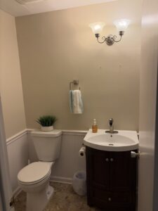 A newly updated powder room with a modern vanity and toilet installed by Mr. Handyman of Northern Pittsburgh, PA.