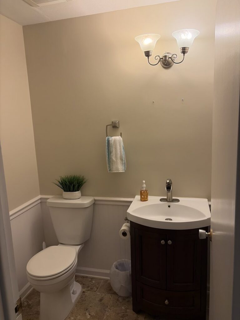 A newly updated powder room with a modern vanity and toilet installed by Mr. Handyman of Northern Pittsburgh, PA.