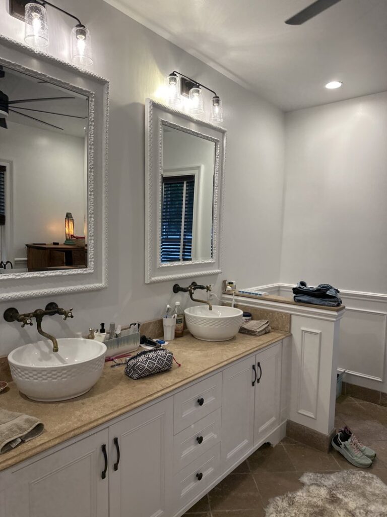 A newly installed bathroom vanity with two vessel sinks and mirrors by Tito's Home Improvement LLC in Stamford, CT.