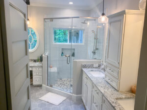 A renovated bathroom with a spacious walk-in shower and double vanity by Berco Construction LLC in Godfrey, IL