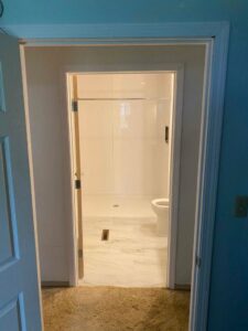 A newly renovated bathroom featuring a walk-in shower and toilet by Thrive Homes, LLC in Olathe, KS.