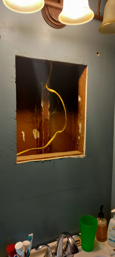 Open wall cavity with electrical wiring, showing handyman work in a bathroom by Arthur brownell jr handyman in Attleboro, MA