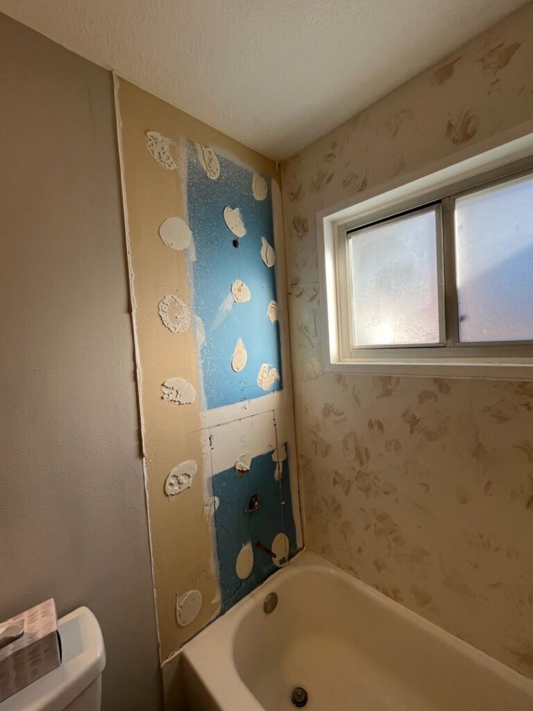 Bathroom wall undergoing repair with drywall removed and plumbing visible, by Ace Handyman ABQ SF in Albuquerque, NM
