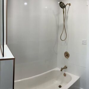 A close-up of a newly installed bathtub and shower fixture in a renovated bathroom by McIntyre's Renovations LLC in Pittsburgh, PA
