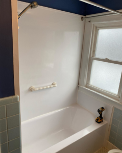 A new bathtub and shower surround being installed during a bathroom renovation by Mohawk Home Improvement of Syracuse LLC in Syracuse, NY.
