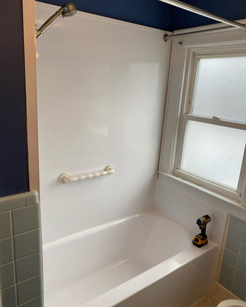 A new bathtub and shower surround being installed during a bathroom renovation by Mohawk Home Improvement of Syracuse LLC in Syracuse, NY.