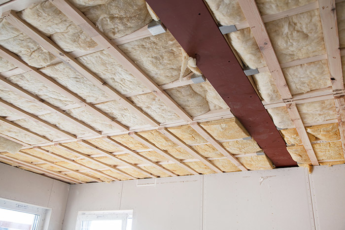 Batt insulation installed between ceiling joists by Custom Insulation Company, Inc. in Worcester, MA