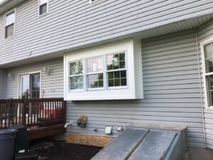 A newly installed bay window on a house exterior, completed by Artstone Exteriors & Renovations in Myersville, MD.