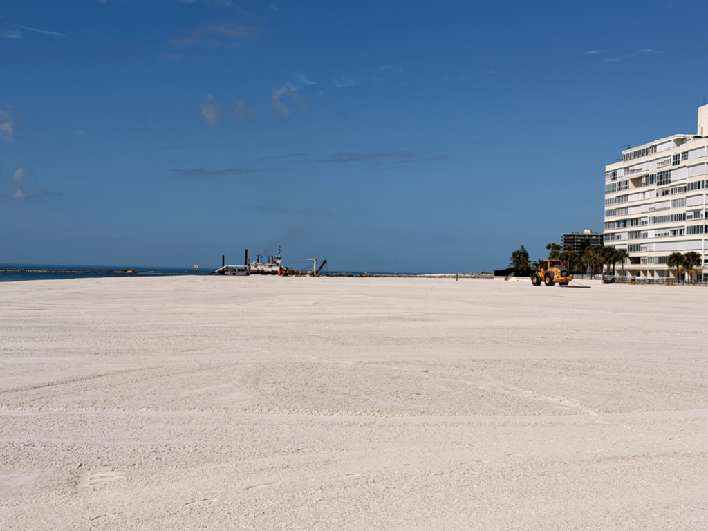 A wide view of a beach renourishment project with construction equipment for Gator Dredging in Clearwater, FL.