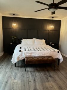 A bedroom featuring a dark accent wall and new lighting installation by Lynden Remodeling in Cincinnati, OH.