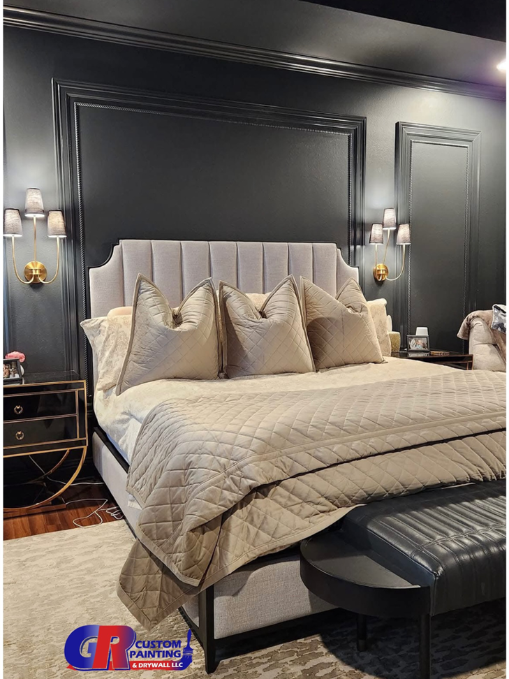 A stylish bedroom with dark painted accent walls and decorative molding by GR Custom Painting & Drywall LLC in Shreveport, LA.