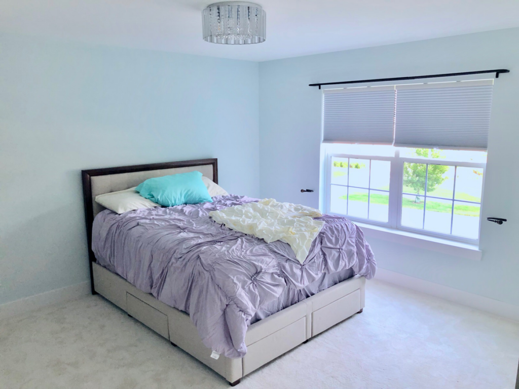 A bedroom with new window blinds and a ceiling light fixture installed by Handyman Helper in Simi Valley, CA.