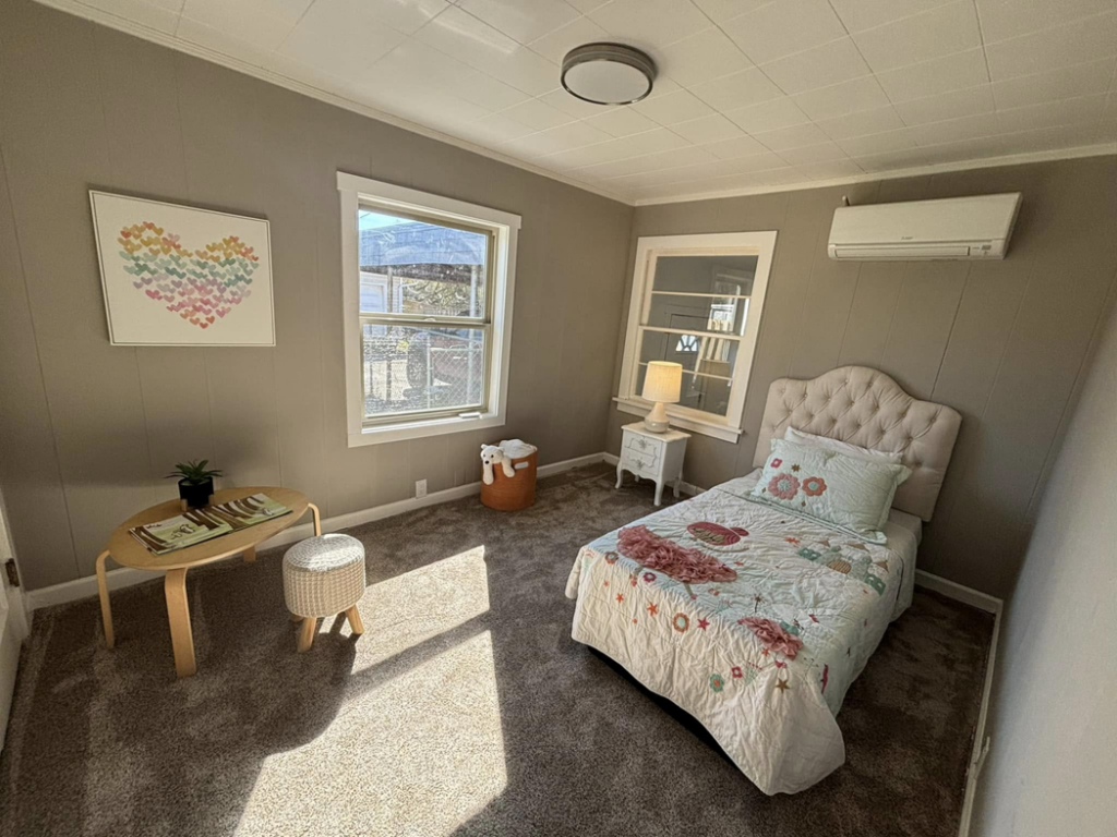 A child's bedroom with new carpet, fresh paint, and a mini-split AC unit installed by A to Z Remodeling llc in Gresham, OR.