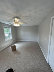 Bedroom with a newly installed ceiling fan and fresh paint by Kings Handyman Services in Dallas, TX