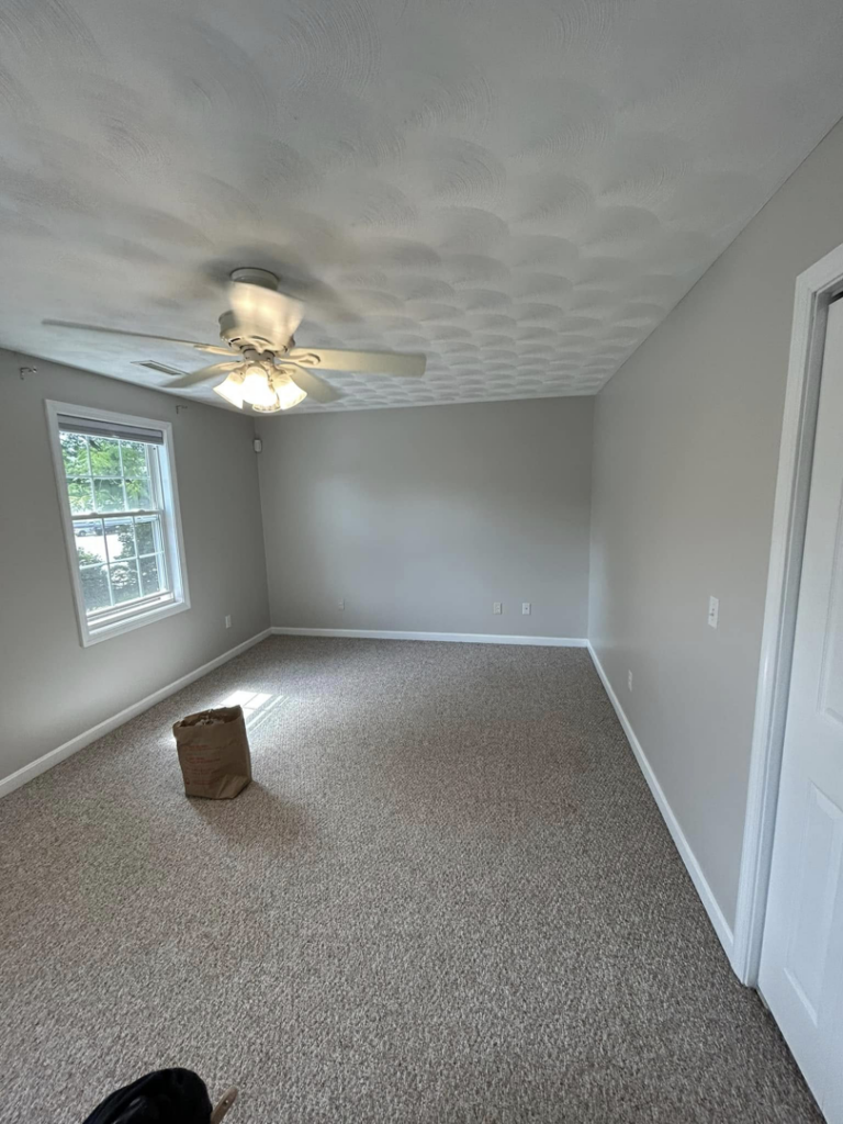 Bedroom with a newly installed ceiling fan and fresh paint by Kings Handyman Services in Dallas, TX
