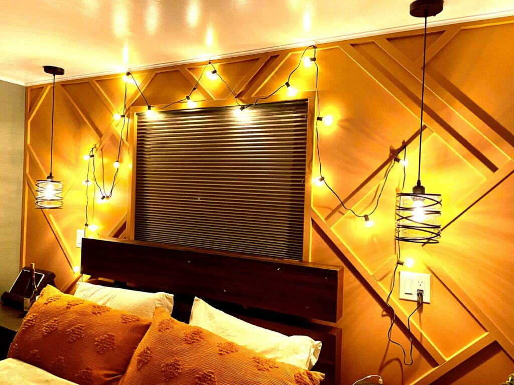 Completed bedroom with decorative lighting and custom wall paneling by Denver House Repair in Lakewood, CO.