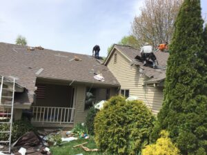 Before and after photos showing a roof cleaning service by Casanova Remodeling in Plymouth, CT.