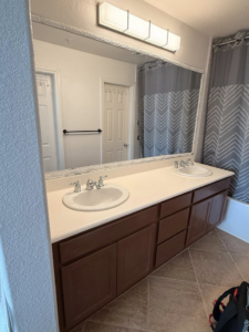 An older bathroom vanity before a complete renovation project by Pauda Handyman in San Diego, CA.