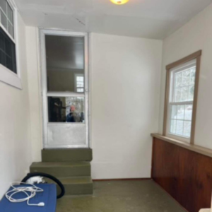 An 'before' view of an entryway needing renovation, showing an old screen door and dirty steps by A 2 Z Home Services - Fairmont WV.