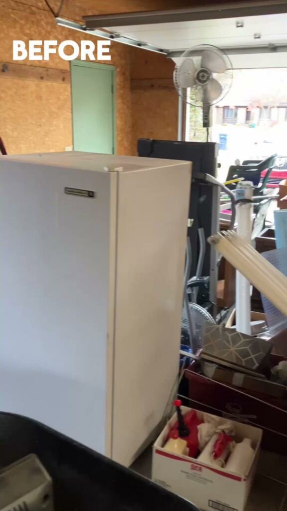 A 'BEFORE' shot of a cluttered garage with a large freezer and various items, ready for cleanout by Feelin Good Junk Removal & Estate Sales at 1111 Debra Lane.